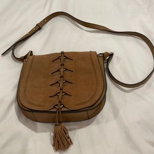 Vince Camuto beige suede bag with brass accents and tassel. 10”wide x 9”tall.